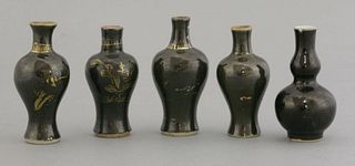 Five black-glazed 'Baby' Vases early to mid-18th