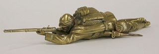 A brass inkwell, c.1900, in the form of a soldier,
