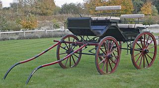 A Victorian horsedrawn four-wheel phaeton, having seats