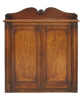 An early Victorian mahogany low cabinet, the shaped top