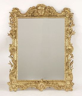 A carved giltwood wall mirror, 19th century, carved
