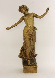 A gilt bronze figure of a lady, her arms raised and