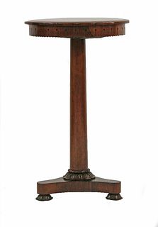 A Recency rosewood lamp table, the circular top over a
