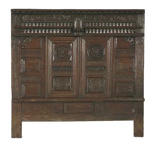 An oak panelled bed front or dole cupboard with 17th