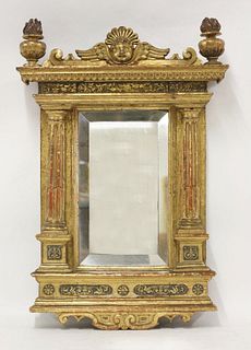An Italian carved giltwood mirror, with winged mask