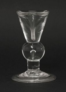 A deceptive baluster Dram Glass, c.1710-1720, with an