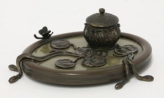 An Art Nouveau bronze inkwell, of oval shape, in the