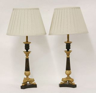 A pair of Regency bronze and parcel gilt candlesticks,