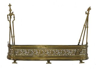 A George III pierced brass fender, with supports to