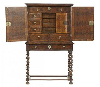 A William & Mary oyster veneered cabinet on stand, the