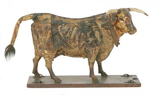 A pull-along papier mÆ’châ€š cow, late 19th century,