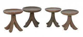 Four Nigerian carved wood stools, having circular