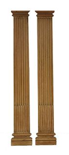 A pair of stripped stop fluted pine pilasters, 268cm