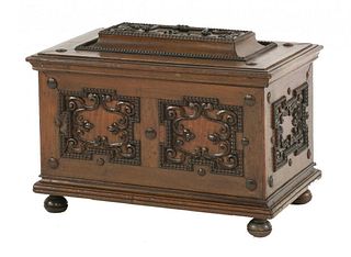 A Continental walnut casket, the hinged top enclosing a