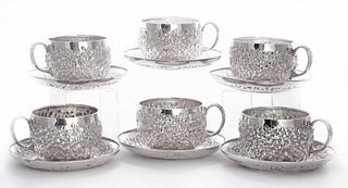 A set of six American silver cups and saucers, by