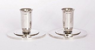 A pair of Georg Jensen silver candlesticks,with import