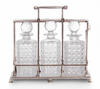 A Victorian silver-plated three bottle tantalus,by