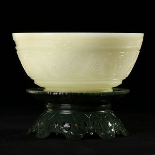 A CARVED WHITE JADE BOWL WITH A GREEN JADE BASE