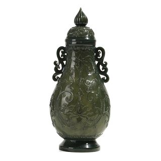 A SPINACH-GREEN JADE VASE WITH HANDLES