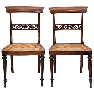 PAR DE SILLAS Ca. 1900 En madera tallada, con asientos en bejuco Detalles de conservación 85 cm de alto | PAIR OF CHAIRS Ca. 1900 In carved wood, seat