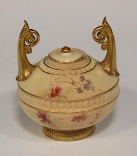 A Royal Worcester blush ivory small urn shaped vase and cover, with scroll foliate handles, floral p