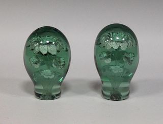 A pair of Victorian green glass dump weights with internal flowers (2) <br> <br>