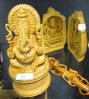 A Chinese carved wood ruyi sceptre and two Indian carved wooden groups depicting Ganesh (3) <br> <br