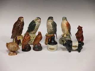 A quantity of novelty ceramic whiskey and spirit decanters in the form of birds of prey and others (