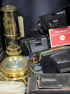 A quantity of cameras, a miners lamp and a brass cased ships wheel style barometer <br> <br>