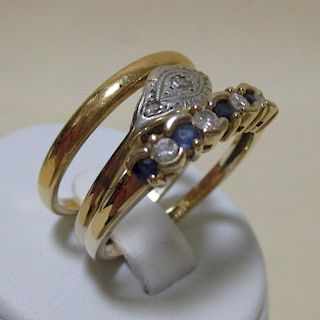 A 22ct wedding band (2.7g), a 9ct sapphire and diamond ring, size P, and a diamond set ring stamped