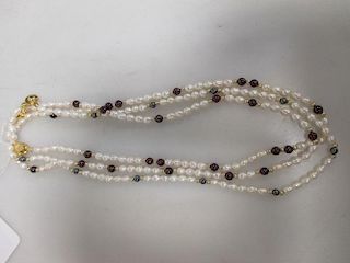 Three pearl necklaces, interspaced with 14 carat gold, garnets or haematite (3) <br> <br>