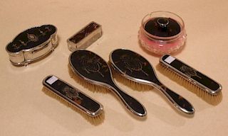 A silver and tortoiseshell matched dressing table set including a jewellery box, powder bowl, pin bo