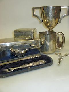 Two silver cigarette boxes, a silver trophy cup, a christening mug, napkin ring, sugar nips and a st