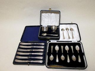 A cased set of silver handled butter knives, a cased set of silver teaspoons, a cased silver christe