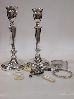 A pair of silver candlesticks (loaded), a silver Peter Pan rattle and two silver bracelets <br> <br>
