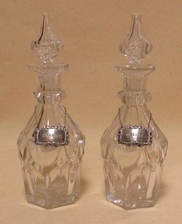 A pair of 19th century glass decanters with silver bottle labels <br> <br>