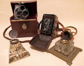 A leather cased Rolliflex camera, another and two glass inkwells <br> <br>