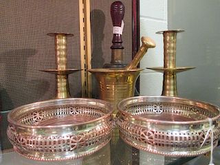 A pair of Queen Anne style brass candlesticks, a brass pestle and mortar, a hand bell and a pair of
