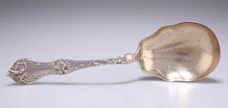 AN AMERICAN ART NOUVEAU STERLING SILVER SERVING SPOON, c.1900, with shell-s