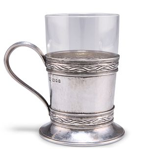 AN ARTS AND CRAFTS SILVER TEA GLASS HOLDER, by Omar Ramsden (1873-1939), Lo