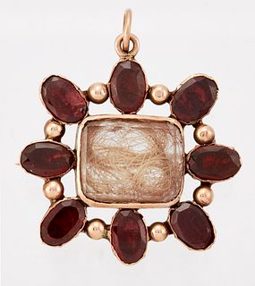 A GARNET MOURNING BROOCH, a central panel containing hair between rock crys