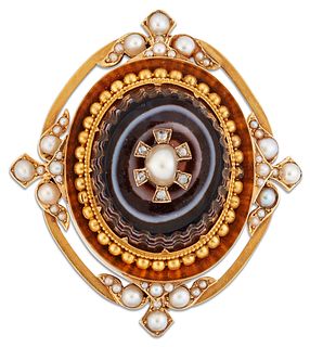 A VICTORIAN AGATE AND SPLIT PEARL BROOCH, a carved oval banded agate inset 