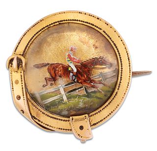 A 19TH CENTURY REVERSE INTAGLIO STEEPLECHASE BROOCH, the circular rock crys
