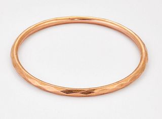A 9 CARAT ROSE GOLD BANGLE, of faceted design, hallmarked Chester 1923. 7.8