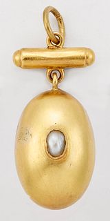 AN EGG PENDANT, set with a seed pearl and suspended from a bar. Measures 2.