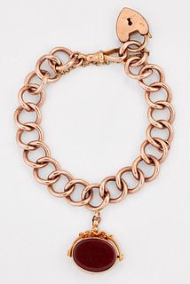 A ROSE GOLD CURB LINK BRACELET, with a gilt metal padlock clasp and suspend