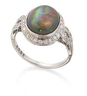 A BLACK OPAL AND DIAMOND CLUSTER RING, an oval opal within a milgrain borde