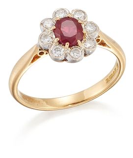 AN 18 CARAT GOLD RUBY AND DIAMOND CLUSTER RING, an oval-cut ruby within a b
