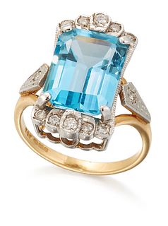 AN 18 CARAT GOLD BLUE TOPAZ AND DIAMOND RING, a rectangular octagonal-cut b