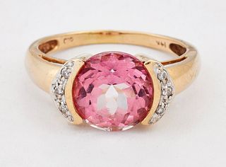 A PINK TOPAZ AND DIAMOND RING, a round-cut pink topaz in a tension setting 